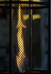 Flame behind grid