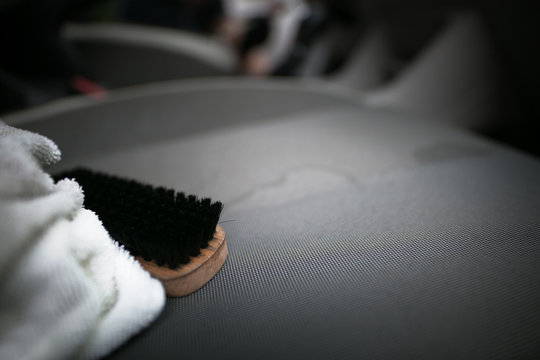 Microfiber Cloth And Brush At The Car Seats During Cleaning