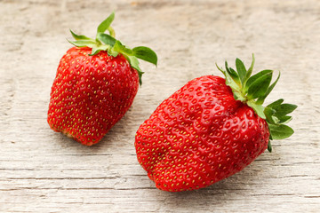 Two large red and ripe strawberries. Close-up.