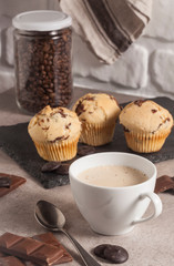 Coffee cup and muffins on the desk.