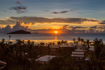 Early morning and sunrise over Pacific Ocean in Mata-Utu village, the capital of Wallis and Futuna territory (Wallis-et-Futuna), French overseas island collectivity. Downtown is overgrown with palms - obrazy, fototapety, plakaty