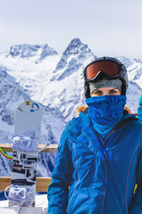Fototapeta na wymiar Woman with ski mask on top of mountains.