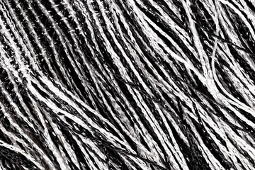 Fragment of creative striped black and white fabric as a background texture.