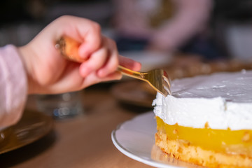 Child stealing a piece of cake