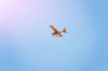 yellow plane flies in the sky, toning