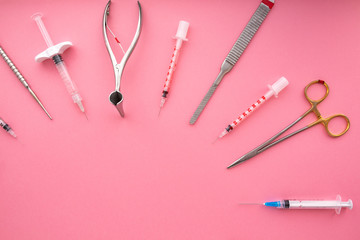 Flat lay of medical instruments on rose background. Mock up health care medical background.