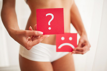 Woman Health Problem. Closeup Of Female With Fit Slim Body Holding Cards With Sad Smiley Face and...