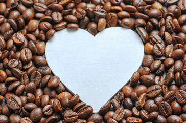 coffee beans roasted as a background with space for text as a heart