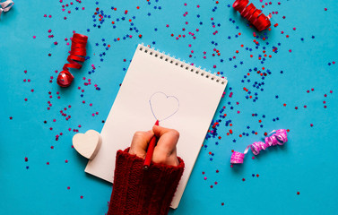 Valentines Day Wishes. Note book on blue background with sparkle