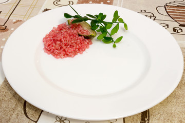 Delicious citrus caviar on a white plate decorated with a green sprig of citrus plants, Microcitrus australasica, Australian finger lime, isolated. Close-up with selective focus