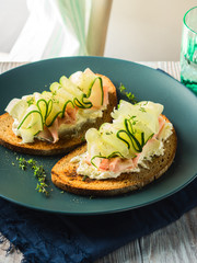 Rye bread toasts with cheese, ham, cucumber