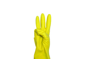 Signs made of yellow protective gloves. Fingers symbol three. Isolated on white. The concept of cleanliness and order.