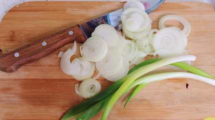 Onion and chives on a board ready to be cooked. Fresh and homemade food it's more nutritive, healthy and cheaper