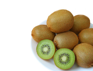 A plate of whole fruits and cross-sections of fresh kiwi fruits isolated on white background 