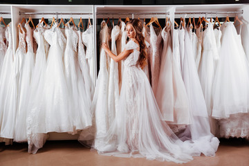 Beautiful bride is trying on an elegant wedding dress