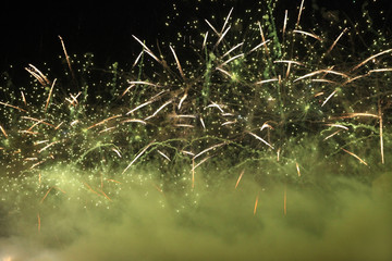 Huge green fireworks in the sky with fog