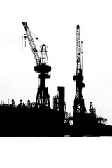 Silhouette of cranes in Hamburg Harbor, Germany,  in black and white.