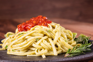 Pasta spaghetti with zucchini, basil, cream and cheese on black stone table. Vegetarian vegetable pasta. Zucchini noodles.