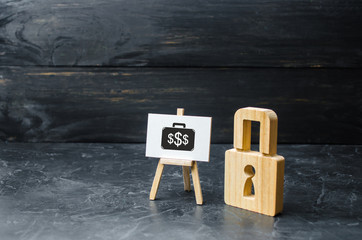 Wooden padlock and sign with the image of investment. Protection money concept. Safe and secure investment, insurance. The economic boom, attracting financial resources and reducing risk.