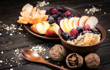 oatmeal with fruit on a wooden background