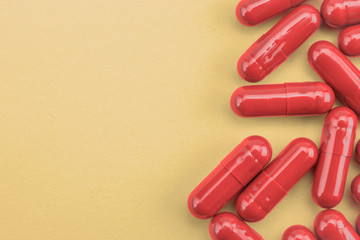 red pills capsules medicine on yellow background
