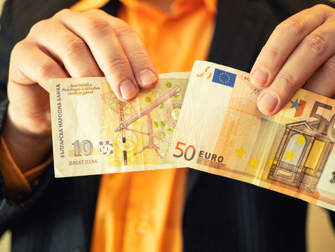 closeup of man hands show Bulgarian lev money in one and fifty Euros in other hand. concept of Bulgaria integration to European Union EU