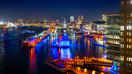 Hamburg Harbor and the  Harbor District in Hamburg, Germany, at night. View of the river Elbe and...