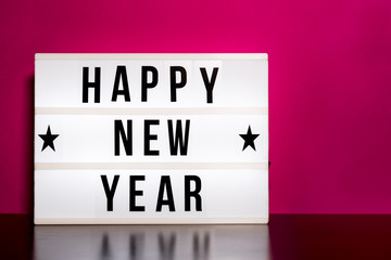  Happy New Year sign - cinema style lettering on light box & hot pink background