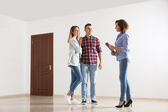 Real estate agent showing new apartment to young couple