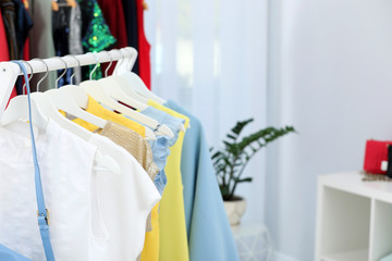 Rack with stylish clothes in boutique, closeup. Space for text