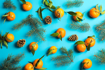 Obraz na płótnie Canvas Christmas composition with ripe tangerines on color background, flat lay