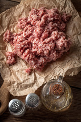 Minced meat on wooden background.