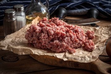Minced meat on wooden background.
