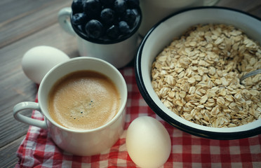 A healthy breakfast - Oatmeal porridge, boiled egg, milk, fresh berries and coffee. A great start to a new day.