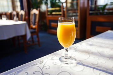 glass of orange juice at the table in restaurant