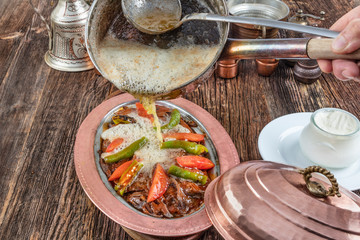 Traditional Turkish Doner Kebab also known iskender. Iskender kebab (iskender kebap). Turkish style doner kebab food on wooden table background.