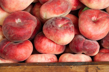 Ripe peaches on the market counter. Close-up.