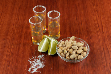 Golden tequila with lemon, pistachos, cacahuate, and salt. Drinks, Liquor
