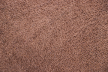 A piece of brown leather. Texture of animal material. Close-up.