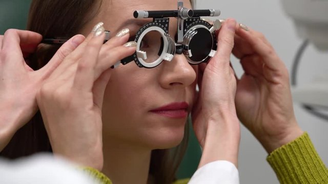 Woman at the reception of an ophthalmologist. Eye examination and selection of spectacle lenses