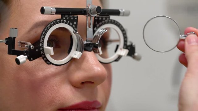 Woman at the reception of an ophthalmologist. Eye examination and selection of spectacle lenses