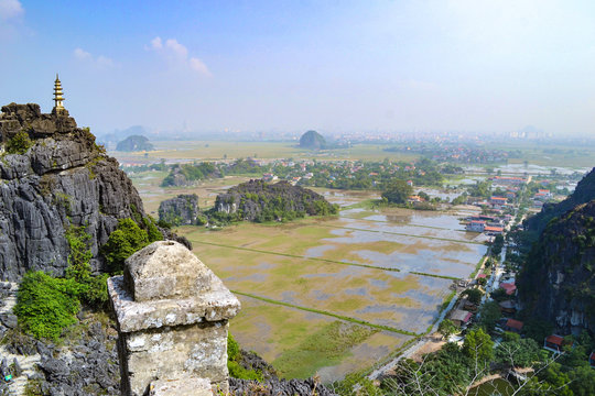 Hang Mua Mountain viewpoint or Mua Caves Ecolodge, Stunning view of Tam Coc area with mountain range, rice fields and waterway.