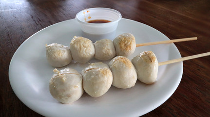 Pork ball skewers on white porcelain plate