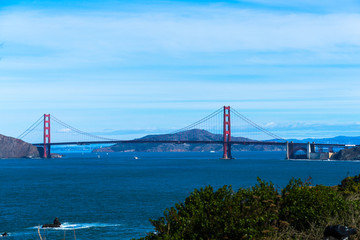 Fototapeta na wymiar The view of golden gate bridge in Lands end at San Francisco- San Francisco. summer , cloud , rock , sea, plant.