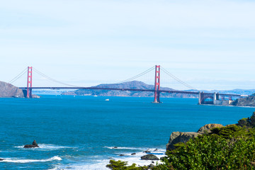 The view of golden gate bridge in Lands end at San Francisco- San Francisco. summer , cloud , rock , sea, plant.
