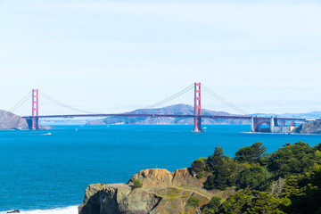 The view of golden gate bridge in Lands end at San Francisco- San Francisco. summer , cloud , rock , sea, plant.