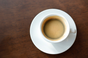 Hot coffee on wood background..