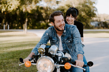 Portrait of Attractive Good Looking Young Modern Trendy Fashionable Guy Girl Couple Riding on Green...