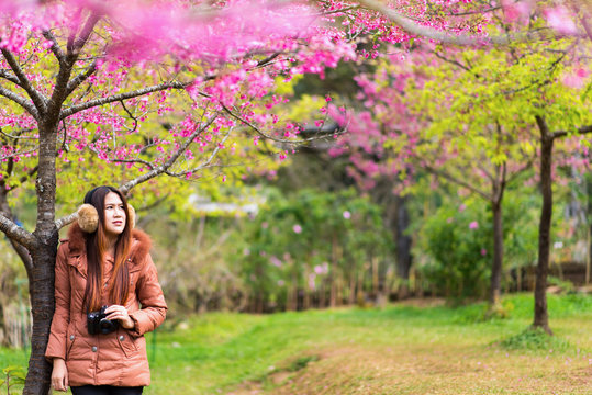 Asian women travel happily in Sakura Garden