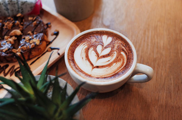 Hot Coffee on wooden table with chocolat on bread